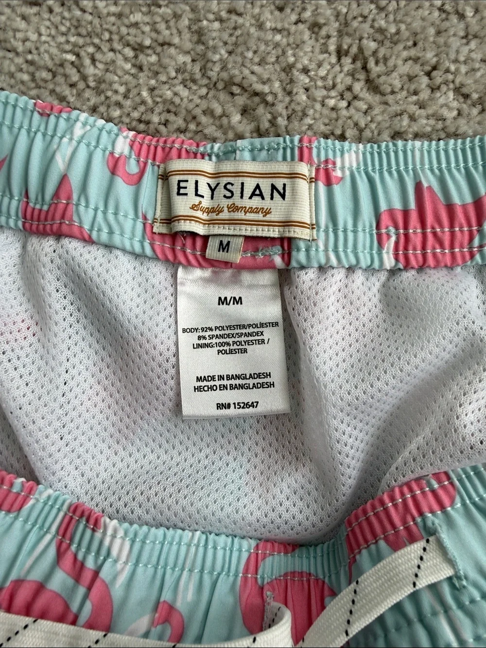 Elysian brand Men’s swim trunks in a blue and pink flamingo print- Size Medium